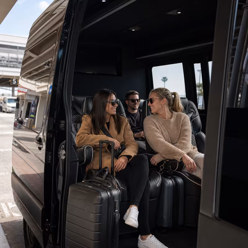 Passengers loading luggage while boarding an Huntington Beach group shuttle