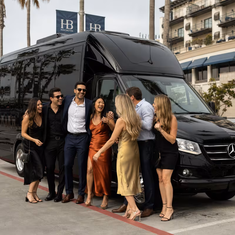 Group boarding a white charter bus for Bachelor & Bachelorette Transportation transportation in Huntington Beach