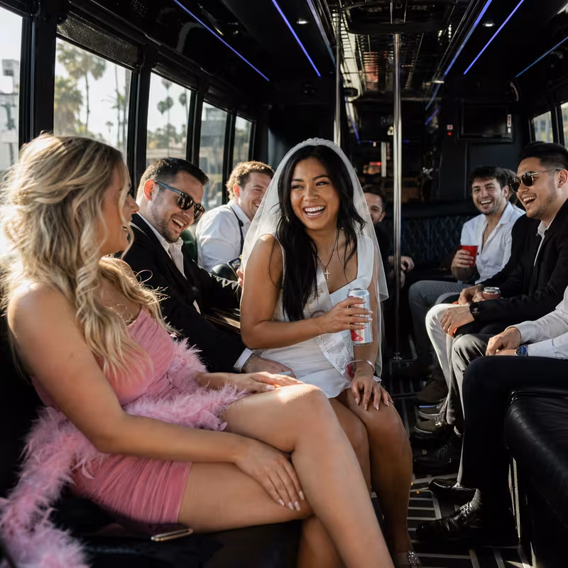 Party bus interior with wraparound leather seating and LED lighting in Huntington Beach