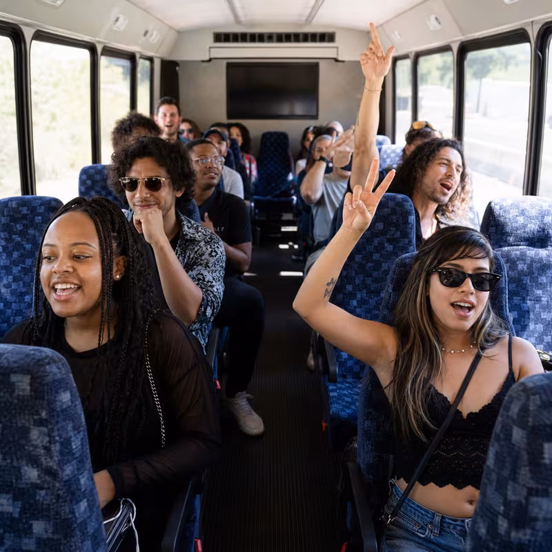 Party bus interior with wraparound leather seating and LED lighting in Huntington Beach