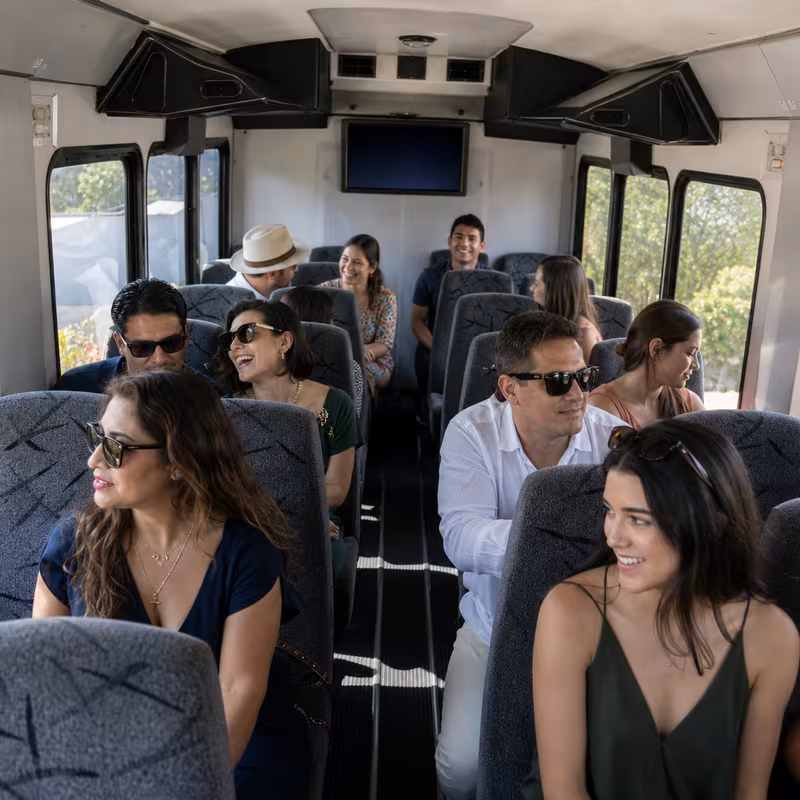 Group boarding a white charter bus for Private Event Transportation transportation in Huntington Beach