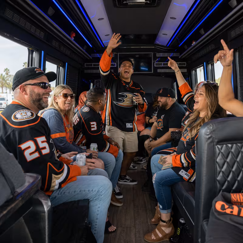 Group boarding a white charter bus for Sporting Event Transportation transportation in Huntington Beach