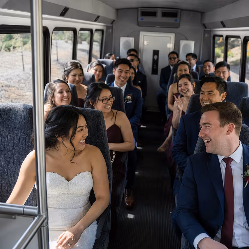 Group boarding a white charter bus for Wedding Transportation transportation in Huntington Beach