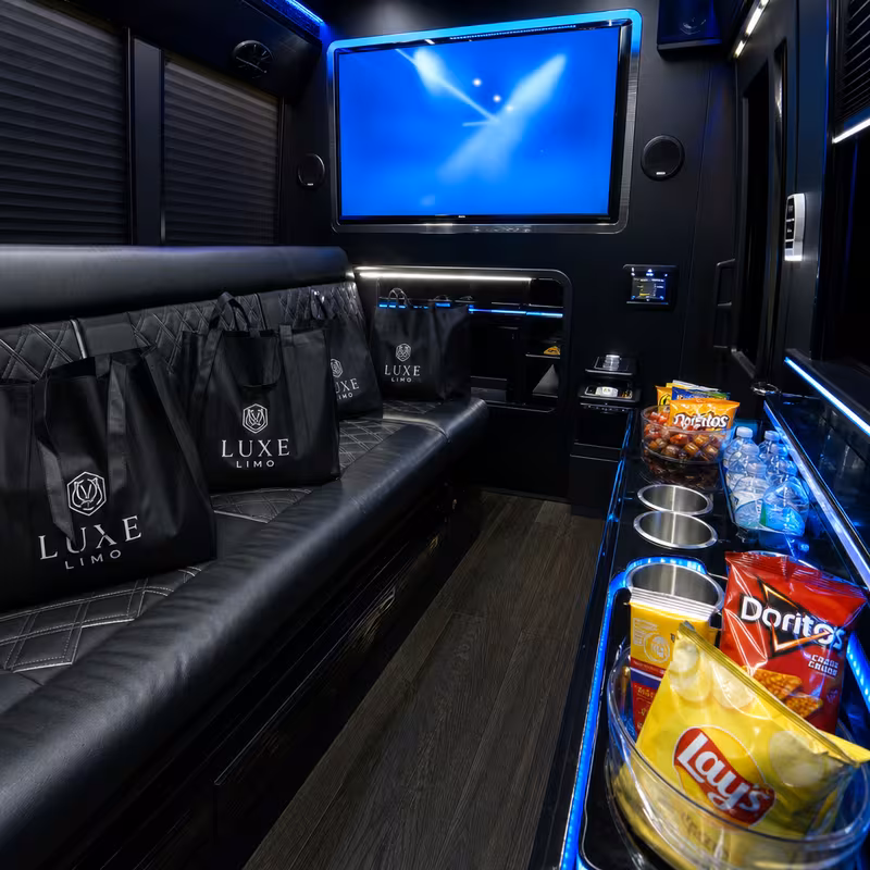 Party bus interior with wraparound leather seating and LED lighting in Huntington Beach